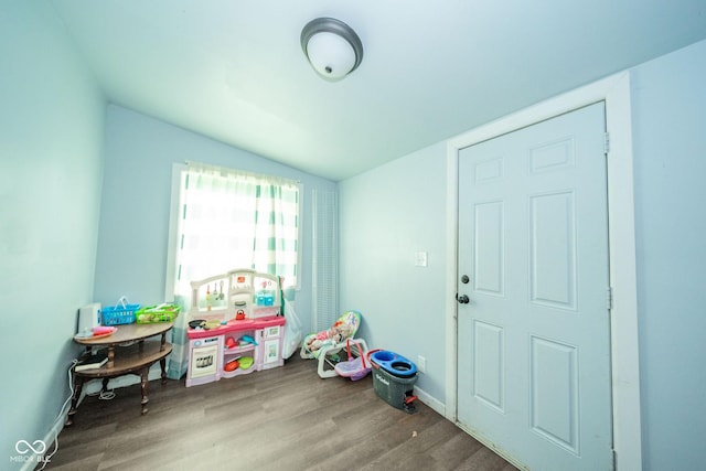 2627 Chase St, Anderson, IN 46016 - playroom with vaulted ceiling and wood finished floors