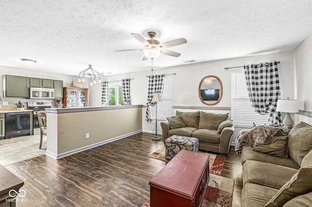 5865 Pennekamp Dr, Plainfield, IN 46168 - living area featuring wood finished floors, ceiling fan, a textured ceiling, and a chandelier