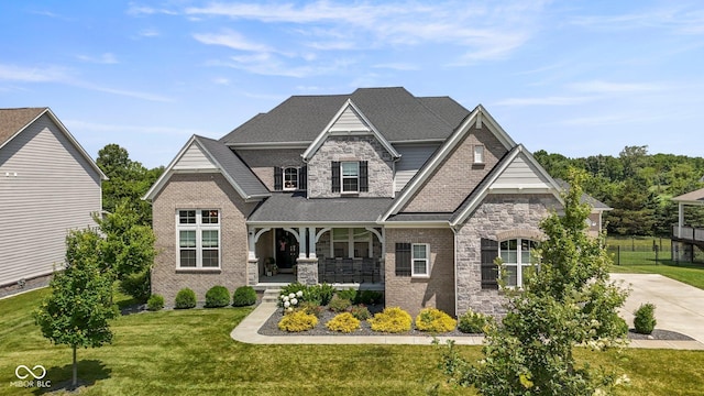 2566 Maple Creek Dr, Westfield, IN 46074 - view of front of home with a porch, stone siding, brick siding, and a shingled roof