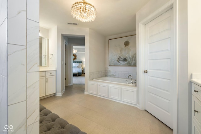 2566 Maple Creek Dr, Westfield, IN 46074 - ensuite bathroom with vanity, a bath, and a chandelier