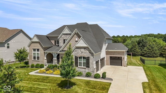 2566 Maple Creek Dr, Westfield, IN 46074 - view of front of home with stone siding, driveway, an attached garage, and a shingled roof