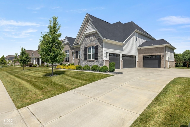 2566 Maple Creek Dr, Westfield, IN 46074 - view of front of house with a front lawn, driveway, an attached garage, stone siding, and brick siding