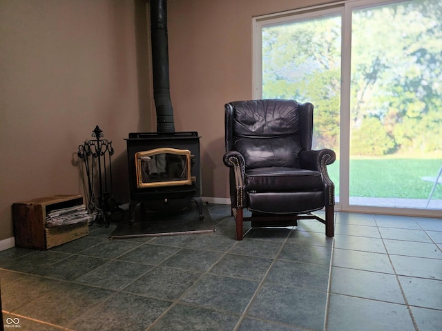 3303 N 850 E, Columbus, IN 47203 - living area featuring a wood stove, plenty of natural light, and tile patterned flooring