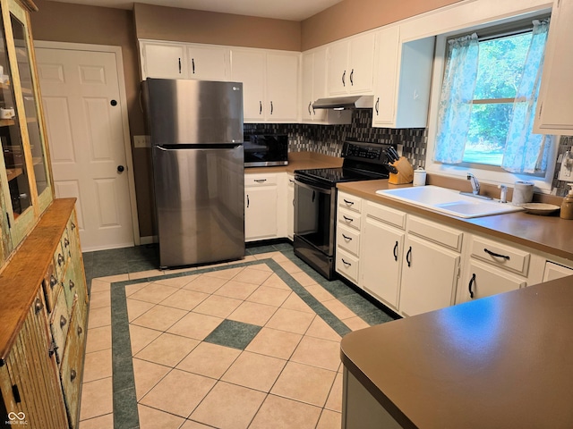3303 N 850 E, Columbus, IN 47203 - kitchen featuring appliances with stainless steel finishes, light tile patterned floors, decorative backsplash, white cabinetry, and range hood