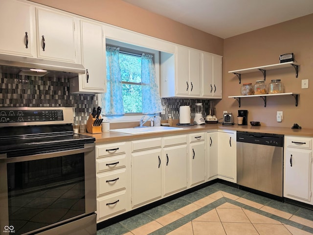 3303 N 850 E, Columbus, IN 47203 - kitchen featuring appliances with stainless steel finishes, under cabinet range hood, light countertops, and backsplash