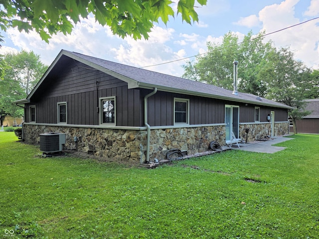 3303 N 850 E, Columbus, IN 47203 - view of property exterior with stone siding and a lawn