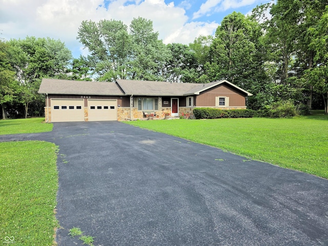 3303 N 850 E, Columbus, IN 47203 - ranch-style home featuring an attached garage, driveway, stone siding, and a front yard