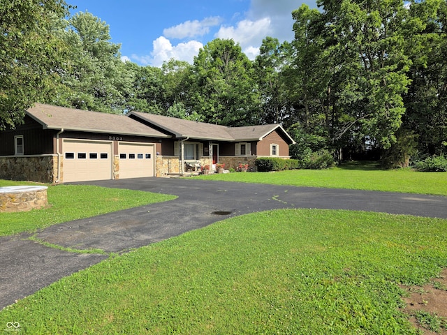 3303 N 850 E, Columbus, IN 47203 - ranch-style house with stone siding, an attached garage, asphalt driveway, and a front lawn