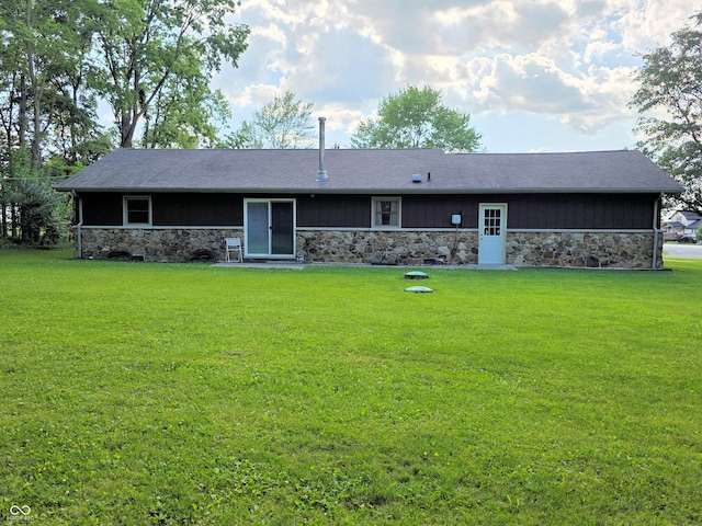 3303 N 850 E, Columbus, IN 47203 - rear view of property featuring stone siding and a yard