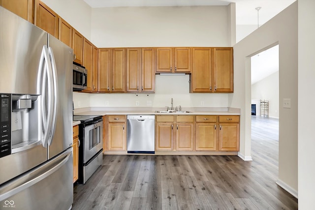 549 Dylan Dr, Avon, IN 46123 - kitchen with appliances with stainless steel finishes, light countertops, wood finished floors, and lofted ceiling