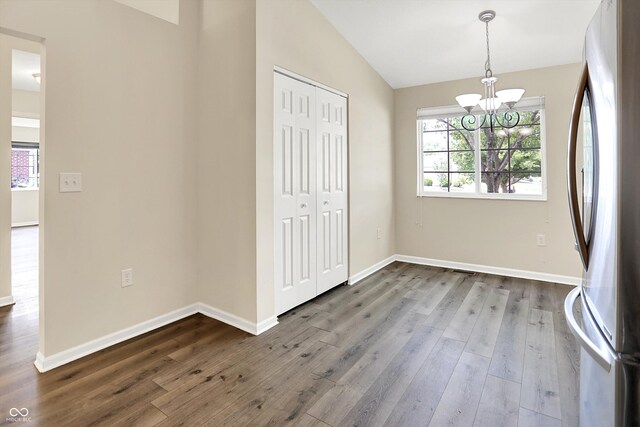 549 Dylan Dr, Avon, IN 46123 - unfurnished dining area featuring a chandelier, lofted ceiling, and dark wood-style flooring