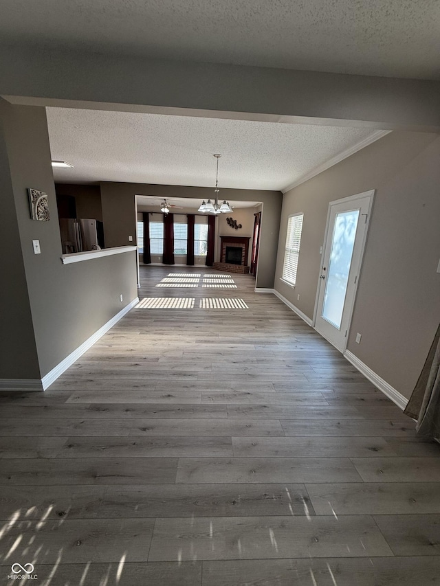 14171 Refreshing Garden Ln, Fishers, IN 46038 - unfurnished dining area featuring a textured ceiling, wood finished floors, and a chandelier