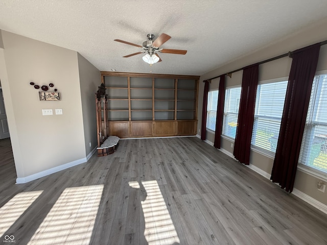 14171 Refreshing Garden Ln, Fishers, IN 46038 - empty room with a ceiling fan, a textured ceiling, and wood finished floors