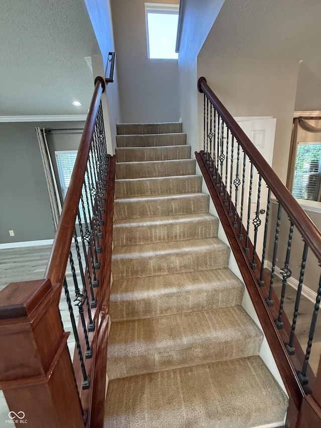 14171 Refreshing Garden Ln, Fishers, IN 46038 - stairway featuring a textured ceiling, healthy amount of natural light, and crown molding