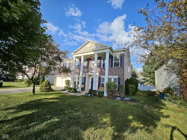 14171 Refreshing Garden Ln, Fishers, IN 46038 - neoclassical / greek revival house featuring a front lawn, brick siding, and driveway