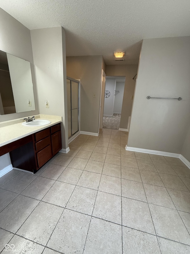 14171 Refreshing Garden Ln, Fishers, IN 46038 - full bath with vanity, tile patterned floors, a textured ceiling, and a shower stall