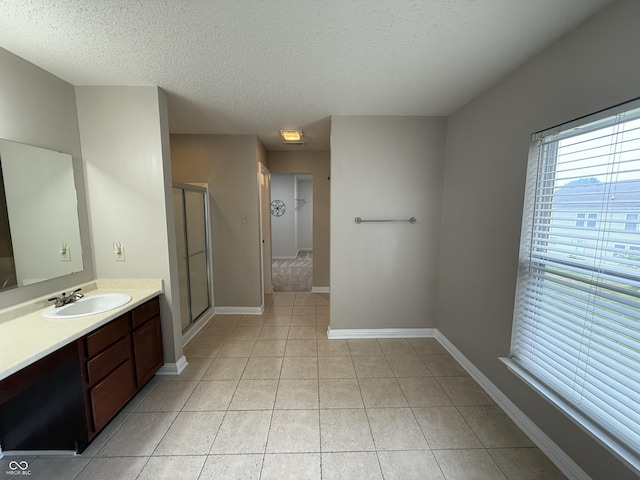 14171 Refreshing Garden Ln, Fishers, IN 46038 - full bath with vanity, a textured ceiling, tile patterned floors, and a stall shower