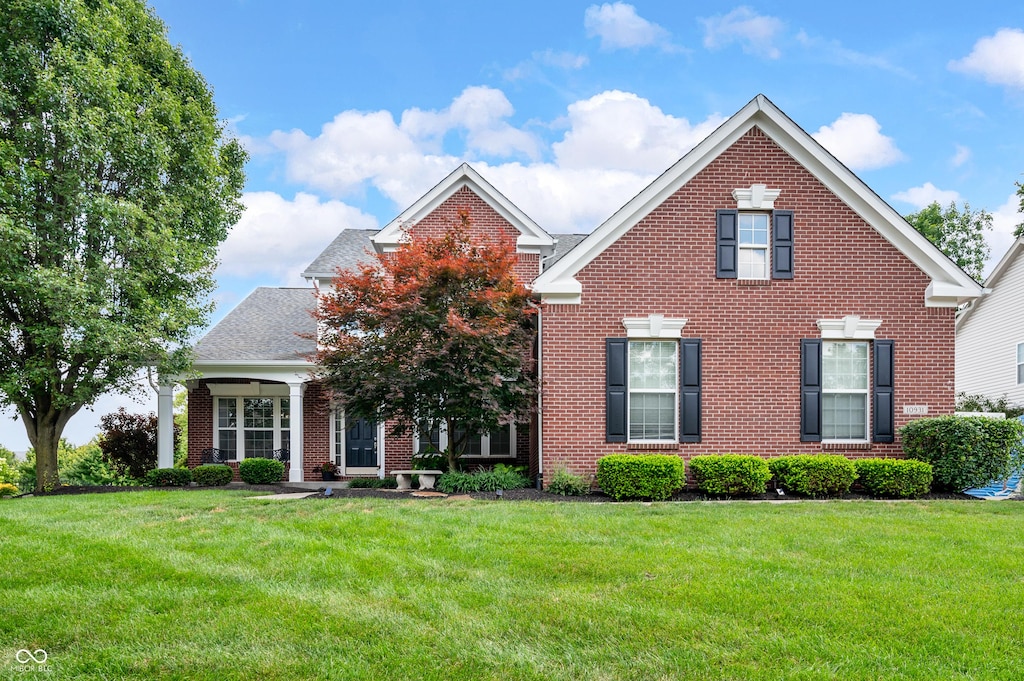 10931 Hidden Hollow Ct, Fishers, IN 46037 - traditional-style home with brick siding and a front lawn