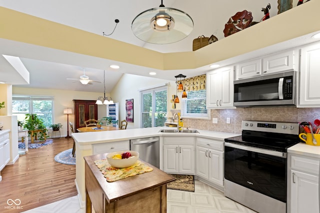 1114 Clairborne Ct, Indianapolis, IN 46280 - kitchen featuring stainless steel appliances, a ceiling fan, a peninsula, light countertops, and white cabinets