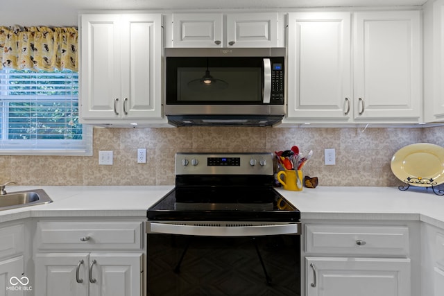 1114 Clairborne Ct, Indianapolis, IN 46280 - kitchen featuring stainless steel appliances, light countertops, white cabinets, and backsplash