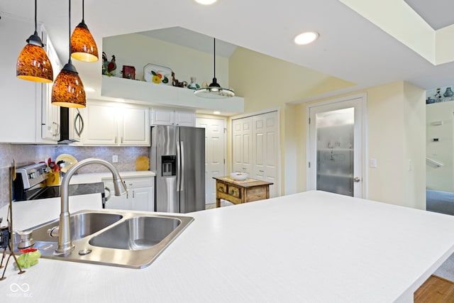1114 Clairborne Ct, Indianapolis, IN 46280 - kitchen featuring appliances with stainless steel finishes, white cabinetry, pendant lighting, decorative backsplash, and light countertops