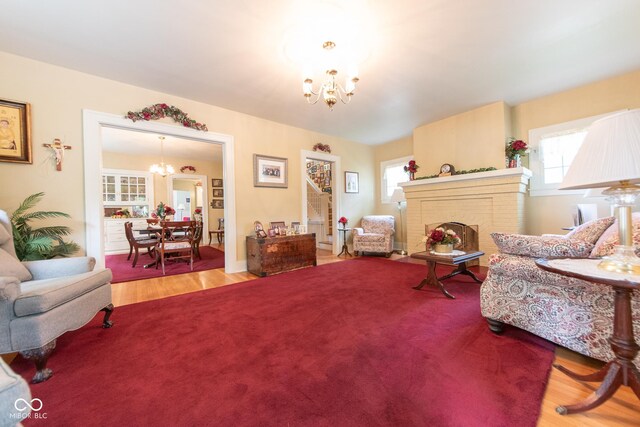 1022 Franklin St, Columbus, IN 47201 - living area featuring a chandelier, wood finished floors, and a fireplace
