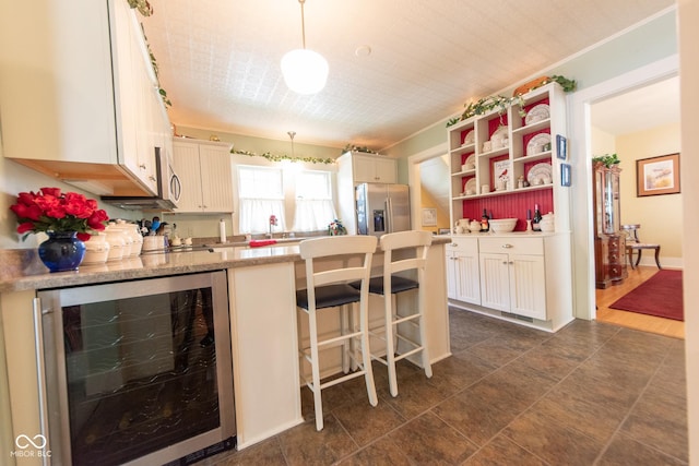 1022 Franklin St, Columbus, IN 47201 - kitchen with beverage cooler, appliances with stainless steel finishes, a peninsula, pendant lighting, and open shelves