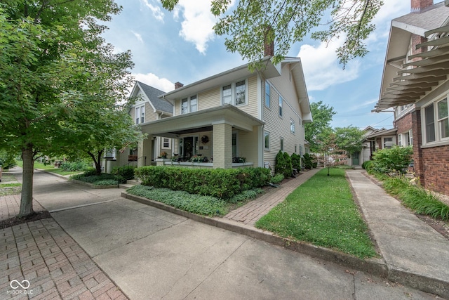 1022 Franklin St, Columbus, IN 47201 - view of front of property with a chimney, covered porch, and brick siding