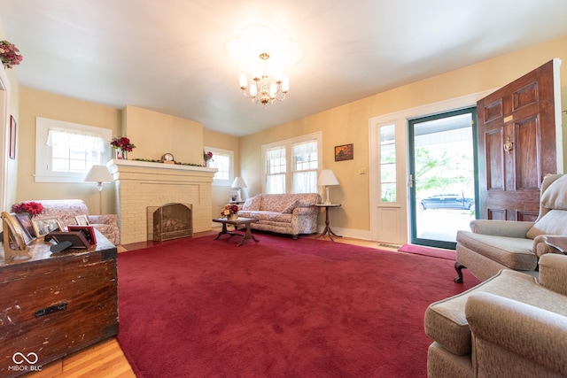 1022 Franklin St, Columbus, IN 47201 - living room with a chandelier, a brick fireplace, and light wood-type flooring
