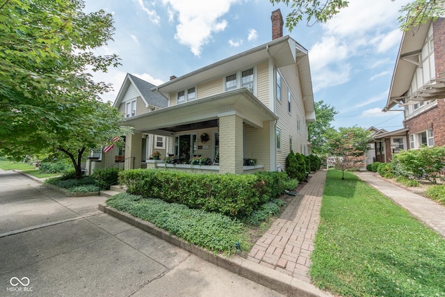 1022 Franklin St, Columbus, IN 47201 - view of front of property featuring a chimney, brick siding, and covered porch