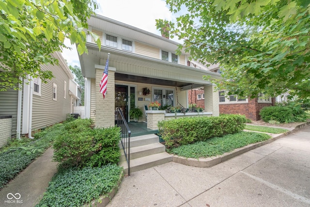 1022 Franklin St, Columbus, IN 47201 - view of front of home featuring a porch and brick siding