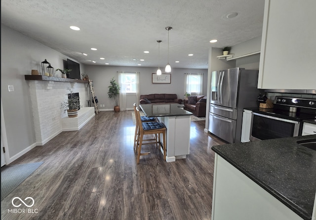 8401 Culpeper Dr, Indianapolis, IN 46227 - kitchen featuring stainless steel appliances, open floor plan, dark countertops, white cabinetry, and recessed lighting