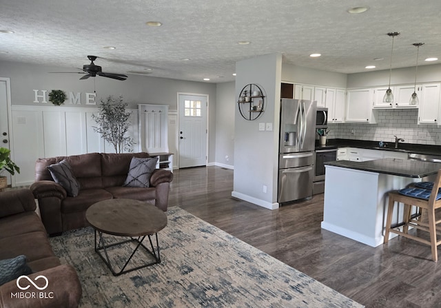 8401 Culpeper Dr, Indianapolis, IN 46227 - living room with a ceiling fan, dark wood finished floors, a textured ceiling, and recessed lighting