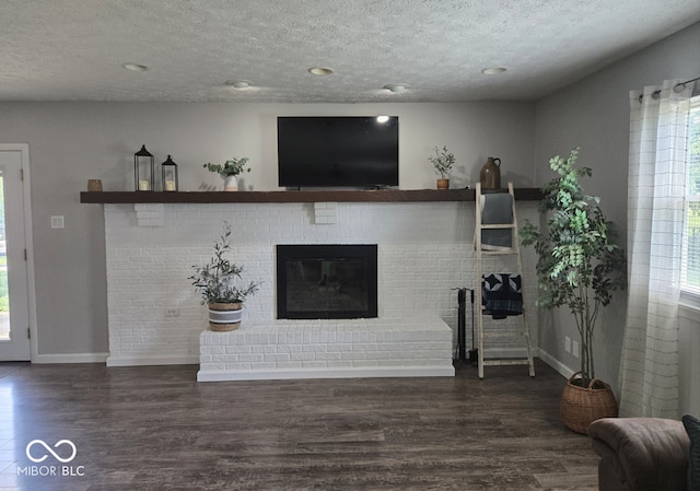 8401 Culpeper Dr, Indianapolis, IN 46227 - living room featuring a textured ceiling, wood finished floors, a brick fireplace, and recessed lighting