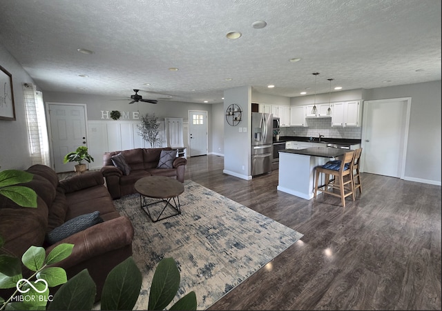 8401 Culpeper Dr, Indianapolis, IN 46227 - living area featuring dark wood-style flooring, recessed lighting, a textured ceiling, and a ceiling fan
