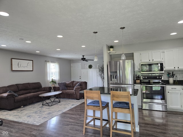 8401 Culpeper Dr, Indianapolis, IN 46227 - living area with dark wood-style floors, recessed lighting, ceiling fan, and a textured ceiling