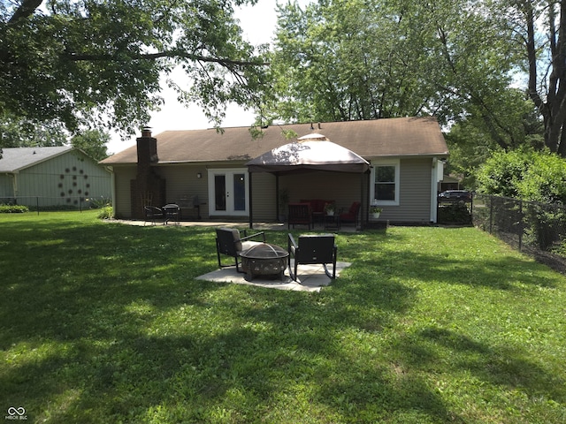 8401 Culpeper Dr, Indianapolis, IN 46227 - rear view of property with french doors, a fire pit, a chimney, a fenced backyard, and a patio area