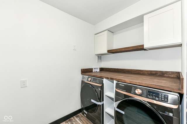 5400 E 200 S, Whitestown, IN 46075 - laundry area featuring separate washer and dryer, cabinet space, and wood finished floors