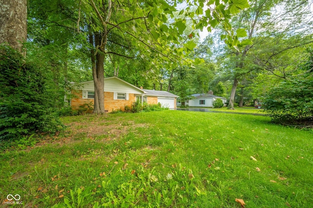 10104 Sycamore Ln, Indianapolis, IN 46239 - view of yard with an attached garage