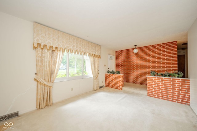 10104 Sycamore Ln, Indianapolis, IN 46239 - unfurnished living room with carpet floors and brick wall