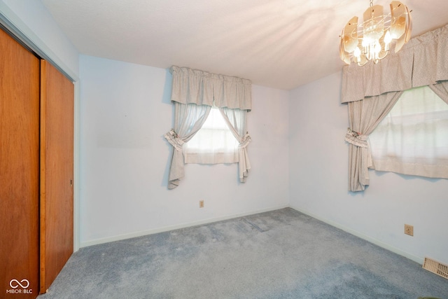 10104 Sycamore Ln, Indianapolis, IN 46239 - unfurnished bedroom featuring a chandelier, carpet, and a closet