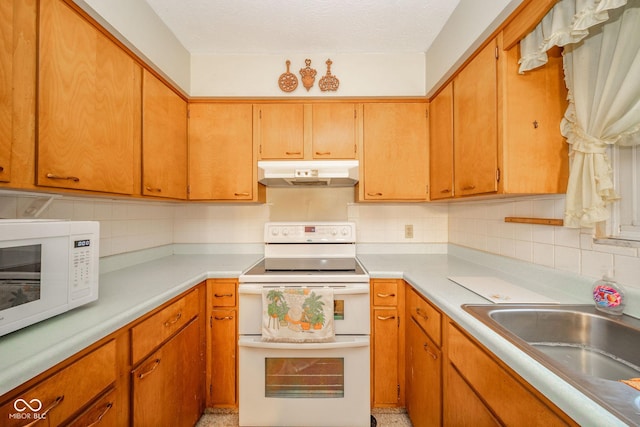 10104 Sycamore Ln, Indianapolis, IN 46239 - kitchen featuring under cabinet range hood, white appliances, decorative backsplash, and light countertops
