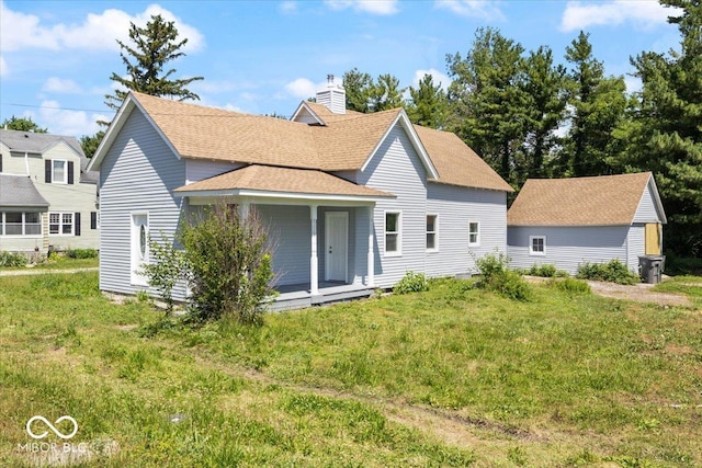 304 W Jefferson St, Kirklin, IN 46050 - rear view of house with a chimney, roof with shingles, covered porch, and a lawn