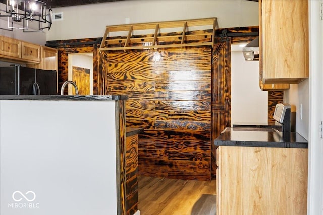 304 W Jefferson St, Kirklin, IN 46050 - kitchen featuring stove, freestanding refrigerator, dark countertops, wood finished floors, and light brown cabinetry