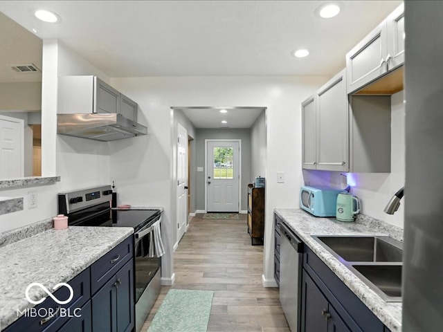 11093 N Pheasant Run, Fairland, IN 46126 - kitchen featuring stainless steel appliances, exhaust hood, light wood finished floors, and recessed lighting