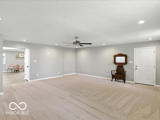 11093 N Pheasant Run, Fairland, IN 46126 - unfurnished living room featuring recessed lighting, light colored carpet, and a ceiling fan