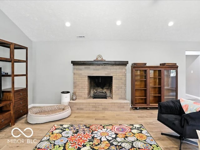 11093 N Pheasant Run, Fairland, IN 46126 - living area featuring wood finished floors, a fireplace, and recessed lighting