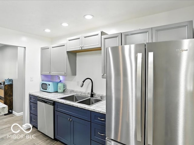 11093 N Pheasant Run, Fairland, IN 46126 - kitchen featuring appliances with stainless steel finishes, light wood-style flooring, recessed lighting, and blue cabinetry