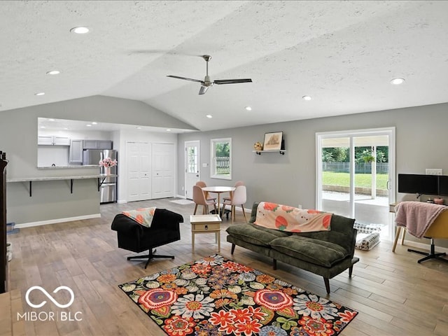 11093 N Pheasant Run, Fairland, IN 46126 - living area with light wood-style floors, recessed lighting, plenty of natural light, a textured ceiling, and vaulted ceiling
