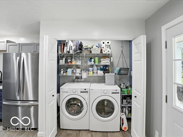 11093 N Pheasant Run, Fairland, IN 46126 - laundry area featuring wood finished floors and washing machine and dryer